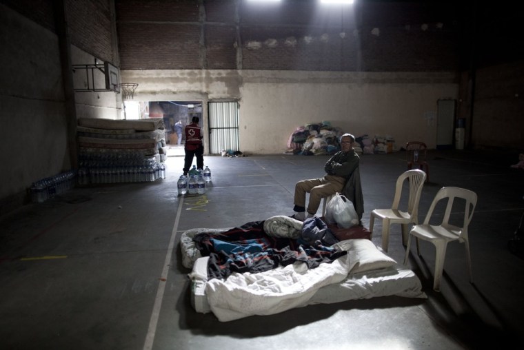 Juan Fernandez sits inside a club where the Red Cross set up a help center for people affected by flooding after his home was damaged in La Plata, in Argentina's Buenos Aires province, on April 4.