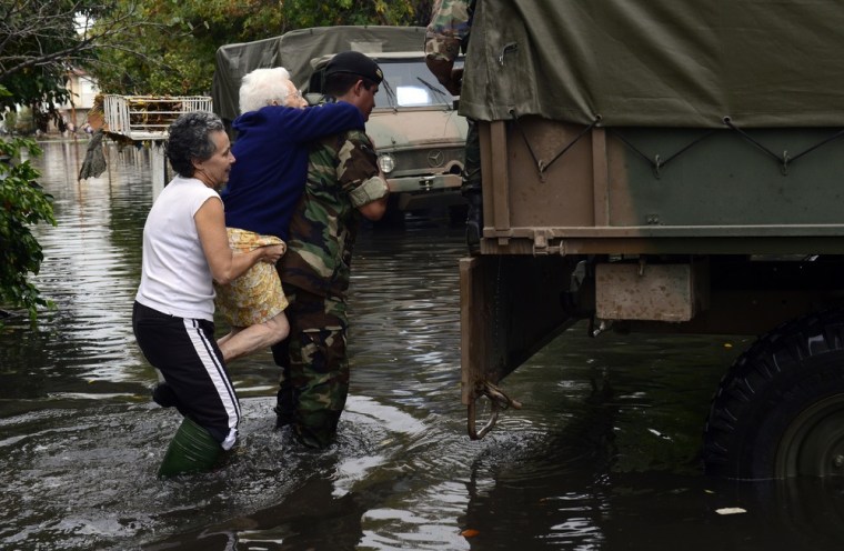 A soldier evacuates an elderly woman in a flooded street in La Plata, 39 miles southeast of Buenos Aires, Argentina, on April 3.