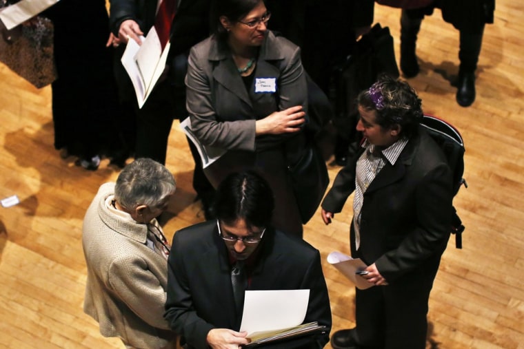 People wait in line to meet a job recruiter at the UJA-Federation Connect to Care job fair in New York in this March 6, 2013 file photo.