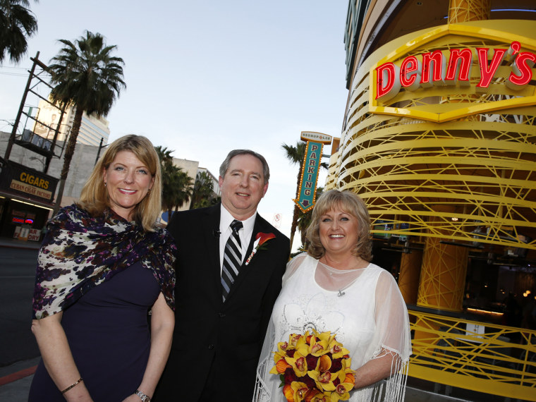 Denny's Chief Marketing Officer, Frances Allen, and newlywed couple Steven Keller and Nancy Keller pose for photos following Denny's on Fremont's first wedding ceremony on April 3, 2013 in Las Vegas.