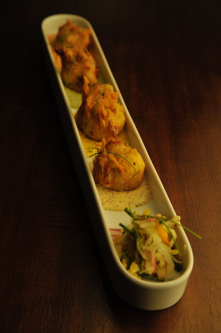 The crab beignet appetizer at R'evolution is one of the most popular items of the menu.