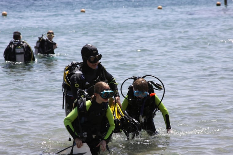 Trainer gives children an introductory dive lesson in Naama Bay in the Red Sea resort town of Sharm el-Sheikh.