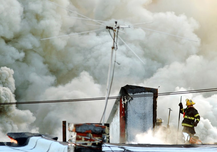 Firefighters battle the blaze that claimed the life of Capt. Michael Goodwin, April 6. The fire caused a partial roof collapse that killed Goodwin and injured a colleague who was trying to rescue him.