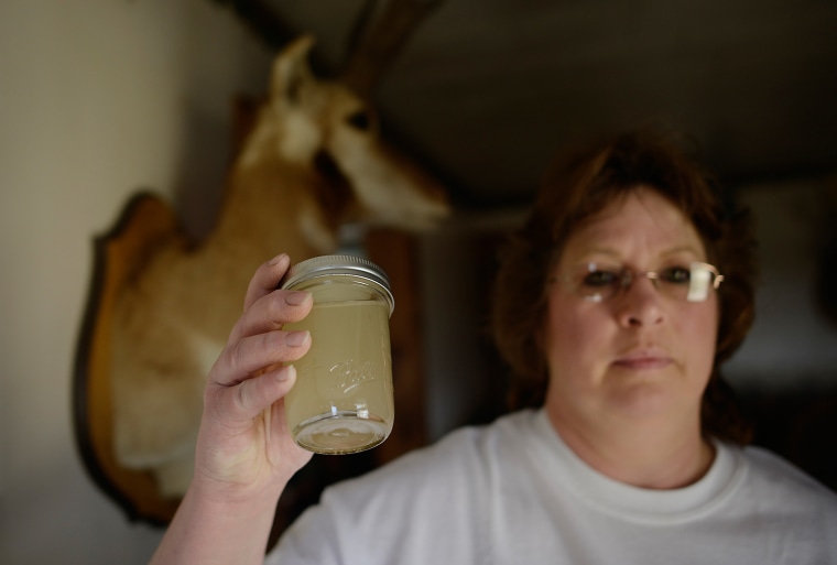 Dairy farmer Carol French holds a jar of water taken in July 2012 from the tap in her home in Sheshequin Township, Pa. French says her water turned cloudy in October 2011, not long after natural gas companies began conducting hydraulic fracturing, or fracking, nearby.
