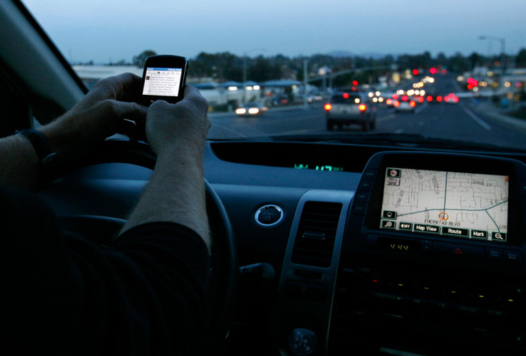 A driver uses his smart phone while in traffic in Encinitas, California December 10, 2009.