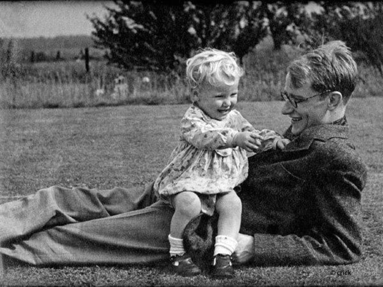 A young Michael Crick sits on his famous father, Francis Crick, in a circa-1943 family photo.
