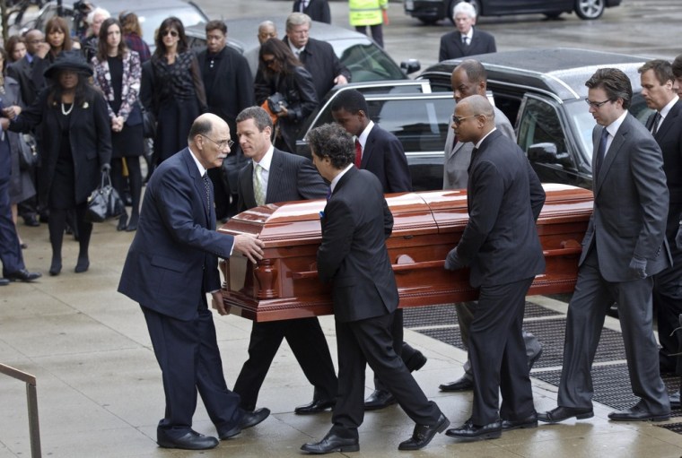Chaz Ebert watches as her husband Roger Ebert's casket is carried in to his funeral in Chicago.
