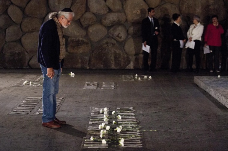 An Israeli man stands in the Hall of Remembrances in the Yad Vashem Holocaust Memorial complex in Jerusalem as Israel marks Holocaust Remembrance Day on Monday.