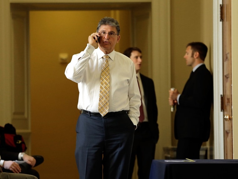 Sen. Joe Manchin, D-W.V., speaks on the phone outside the weekly Democratic policy luncheon April 9, 2013 in Washington, DC.
