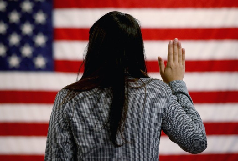A woman takes the oath of allegiance during a naturalization ceremony in Newark, N.J., in January.
