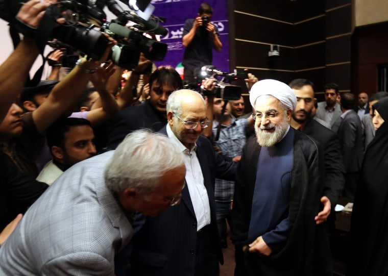 Former chief nuclear negotiator Hassan Rowhani, center, arrives at a conference in Tehran on Thursday where he announced his candidacy for the June presidential election. Rowhani is considered a moderate who could work with the West.