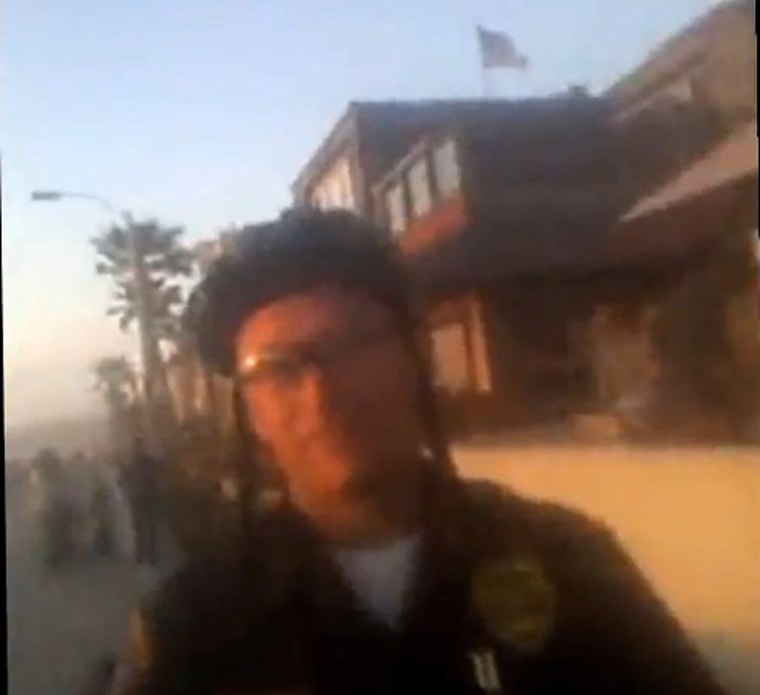 A still from a video of a San Diego police officer asking Adam Pringle to surrender his phone.