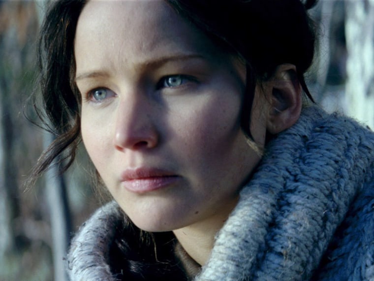 Jennifer Lawrence as Katniss Everdeen and Willow Shields as Primrose Everdeen in