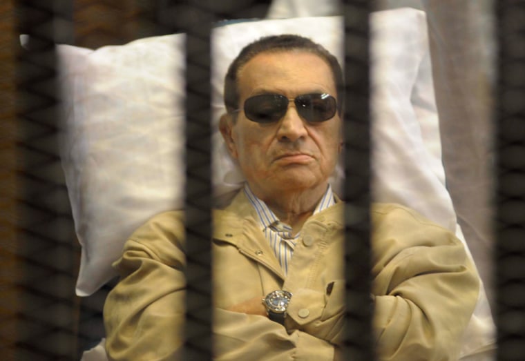 Former Egyptian President Hosni Mubarak sits inside a cage in a courtroom in Cairo on June 2, 2012.