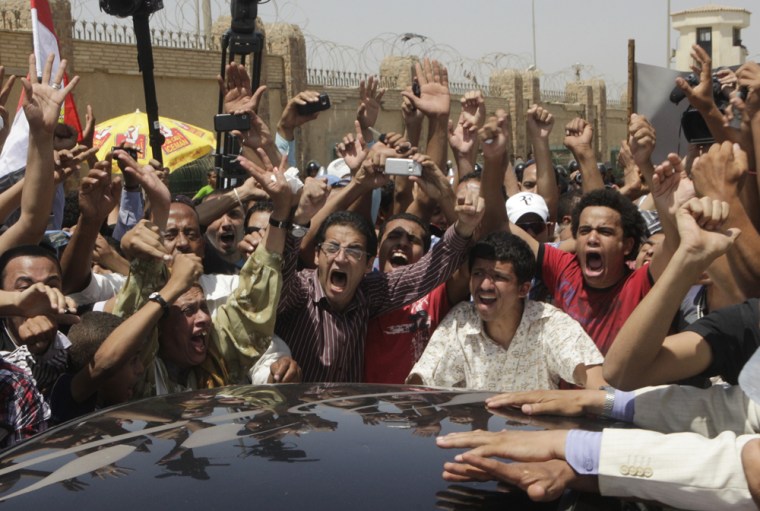 Egyptians celebrate in Cairo as they hear from a car radio that ousted president Hosni Mubarak has been sentenced to 25 years in prison.