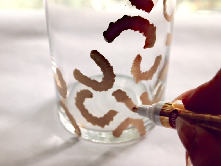 First be sure that your vase is clean and free of residue. Then use your paint pen to directly apply your pattern. I chose a leopard design, but you c...