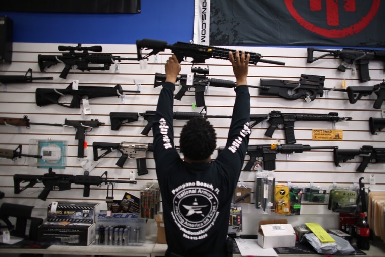 As the U.S. Senate takes up gun legislation in Washington, DC , Mike Acevedo puts a weapon on display at the National Armory gun store on April 11, 2013 in Pompano Beach, Florida.