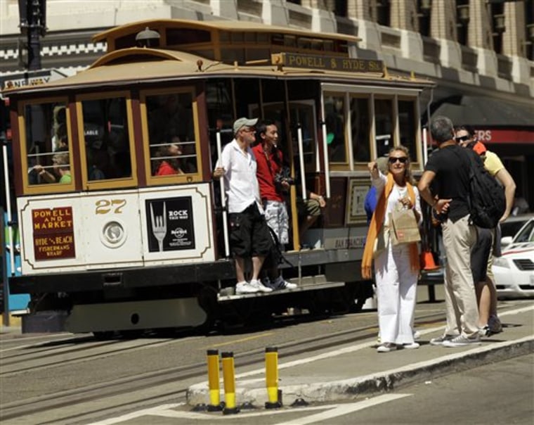 Visitors wait to board a cable car in San Francisco's Union Square in 2010.