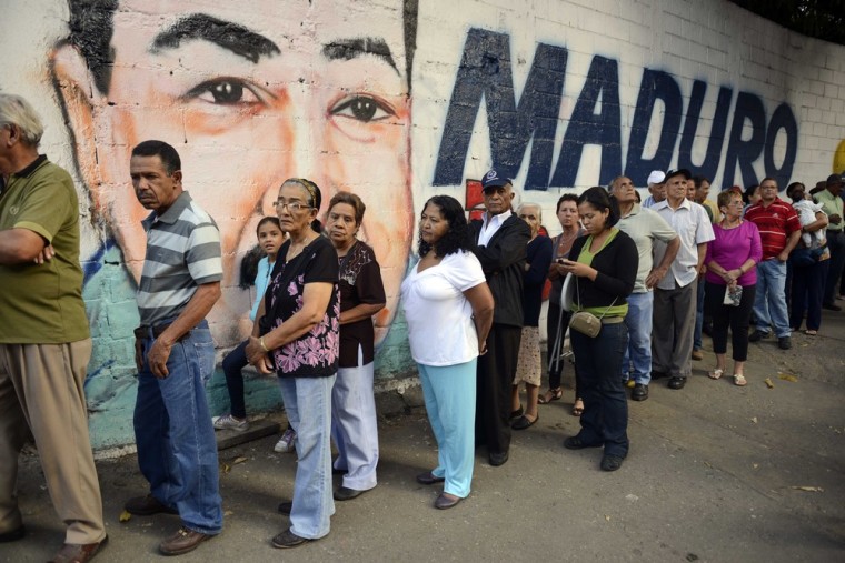 People line up to cast their vote at a polling station in Petare shantytown, Caracas, on April 14, 2013. Venezuelans headed to the polls on April 14.