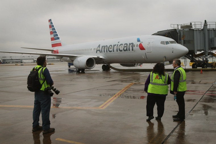 CHICAGO, IL - JANUARY 29: A new American Airlines 737-800 aircraft featuring a new paint job with the companyâ€™s new logo sits at a gate at O'Hare A...