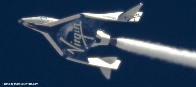 A trail of oxidizer streams behind the SpaceShipTwo rocket plane during Friday's gliding test flight.