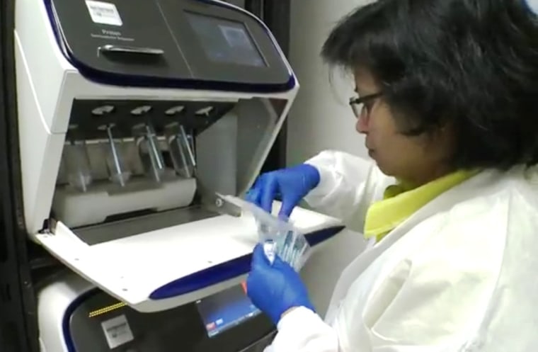 A researcher initializes an Ion Proton system at the Baylor College of Medicine Human Genome Sequencing Center in Houston. Ion Torrent says the benchtop device is designed to sequence a human genome in a day for less than $1,000.
