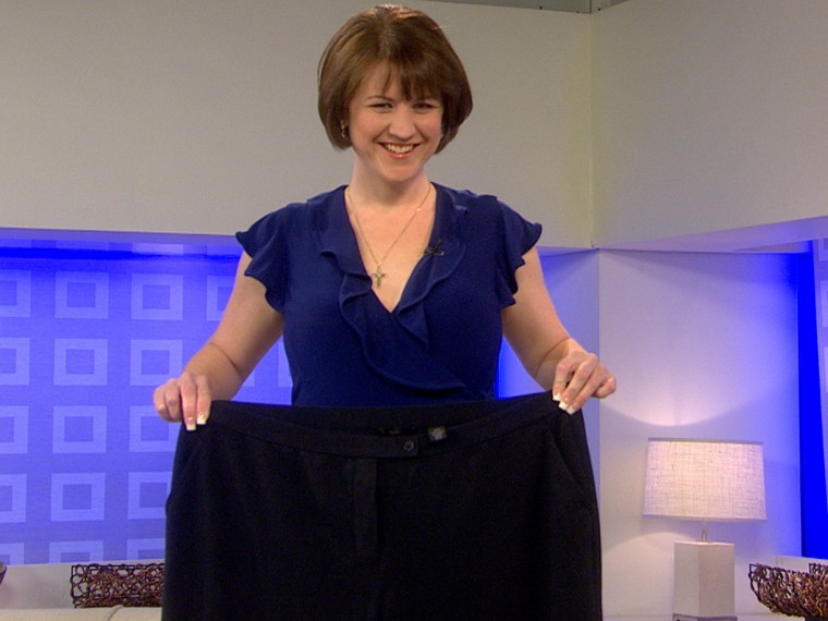 Kristen McCamy holds up her pre-weight-loss pants. Inspired to raise money for a sick friend, she lost 125 pounds.