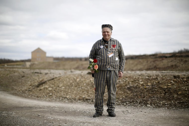 Survivor Petro Mischtschuk, 87, from Ukraine, wears his old prisoner's garb as he stands near the memorial site of the Little Camp at Buchenwald.