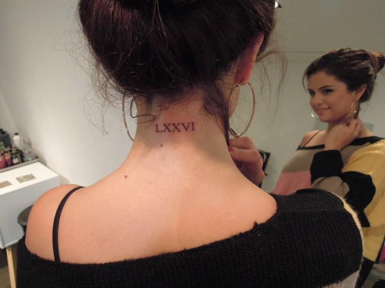 Selena Gomez and her new ink. The Roman numerals translate to \"76,\" which she says is a tribute to a family member.