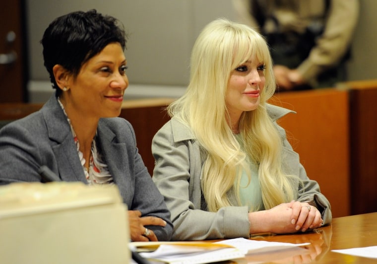 Lindsay Lohan, right, sits in court for her probation update hearing with attorney Shawn Chapman Holley on Wednesday, Feb. 22 in Los Angeles.