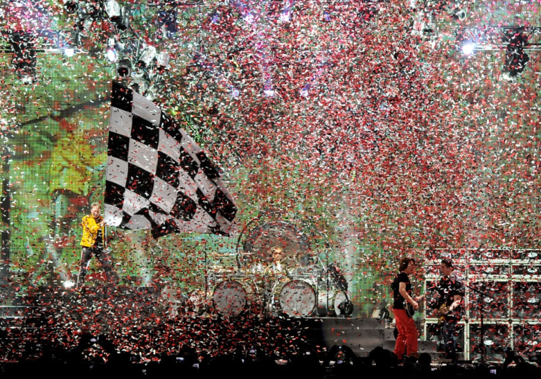 Confetti flies inside the Forum as Roth waves a giant checkered flag.