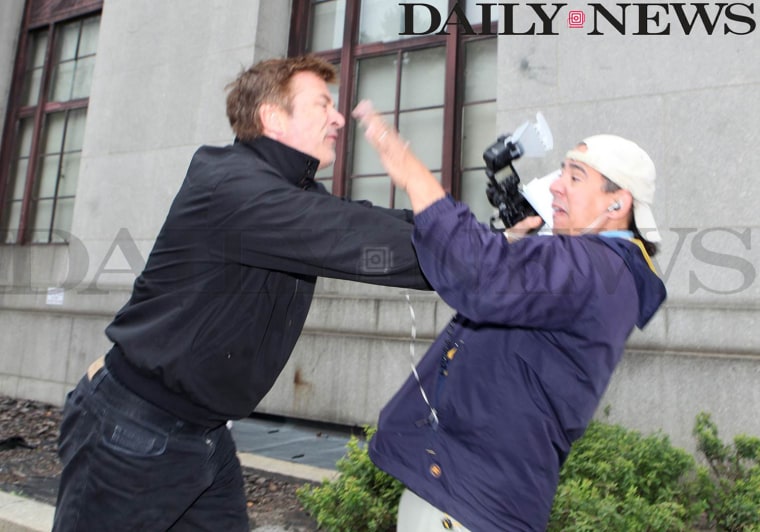 Alec Baldwin, left, scuffles with New York Daily News photographer Marcus Santos outside the Marriage License Bureau in New York on Tuesday morning.