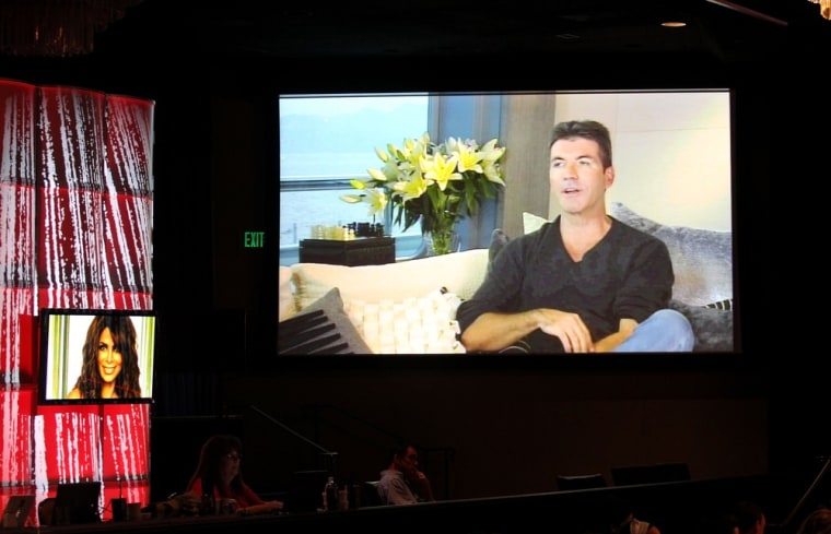 Simon Cowell speaks onscreen at \"The X Factor\" panel during the FOX portion of the 2011 Summer TCA Tour at the Beverly Hilton Hotel on Friday.