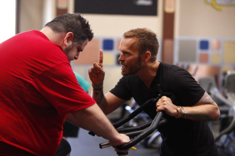 On the first day at the ranch, trainer Bob Harper, right, gives words of encouragement to contestant Mark Pinhasovich.