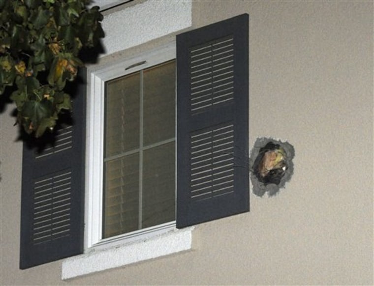 The exit hole from a misfired cannonball is seen in the second story wall of a home. The cannonball misfired during the taping the Discovery Channel show \"MythBusters.\"