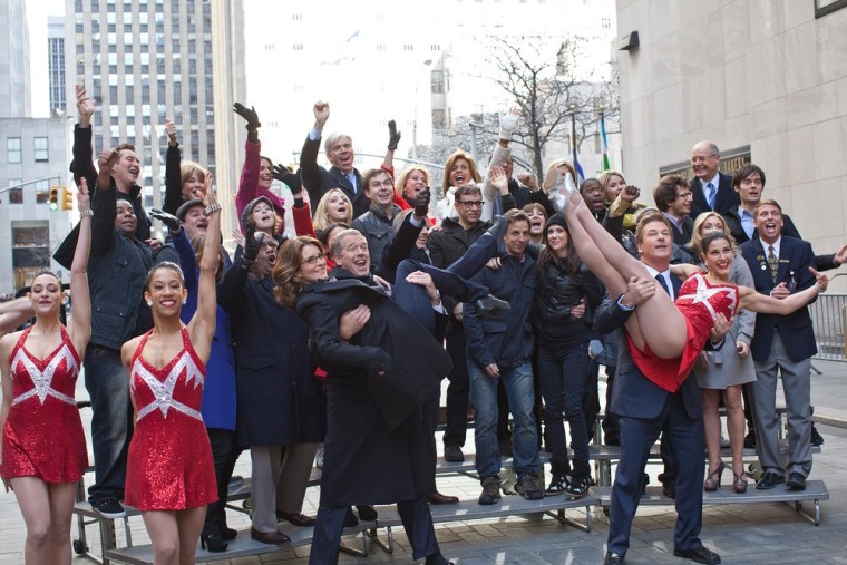Brian Williams carries \"30 Rock\" star Tina Fey  in the big finale for the \"Brotherhood of Man\" commercial.