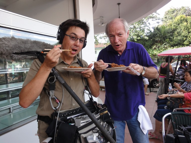 Kyle Eppler and Mark Roberts take a break from filming to try the Penang street food.