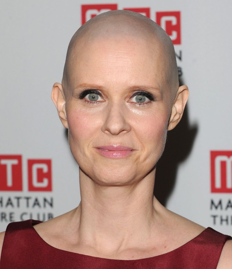 Cynthia Nixon, who shaved her head for her new Broadway role, is now clarifying her earlier statement that she believed being gay is a choice.
