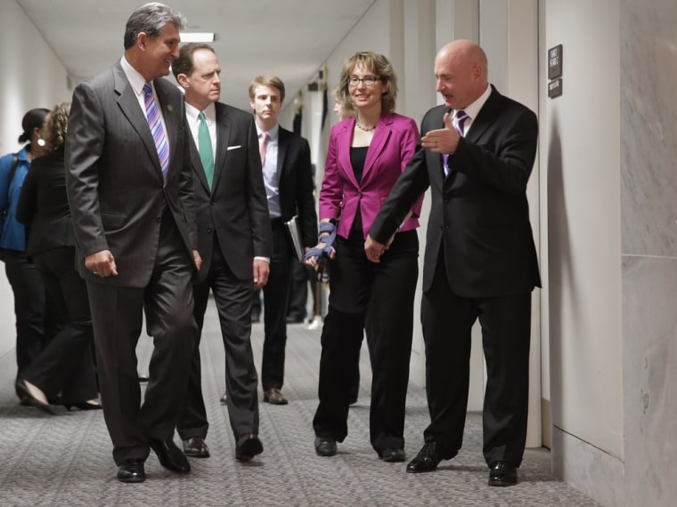 Shooting victim and former Rep. Gabrielle Giffords, D-Ariz., and her husband and retired astronaut Mark Kelly, right, join Sen. Joe Manchin, D-W.V., and Sen. Pat Toomey, R-Pa., in the Hart Senate Office Building on Capitol Hill April 16, 2013.