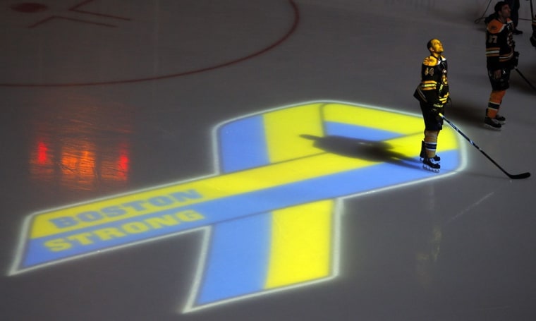 Boston Bruins Dennis Seidenberg observes a moment of silence for the victims of the Boston Marathon bombings before the start of an NHL hockey game against the Buffalo Sabres at TD Garden in Boston, Mass., on April 17, 2013. This is the first sporting event to be held in Boston after the explosions that killed three and injured more than one hundred at the Boston Marathon.