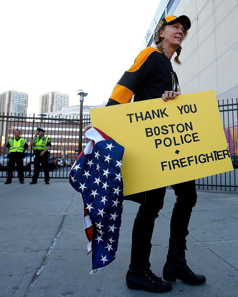 A Bruin fans shows her support for the efforts of the Boston police and firefighters before a game Wednesday night.