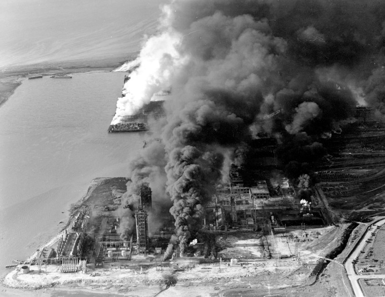 Refineries and oil storage tanks at a Monsanto chemical plant burn after a ship being loaded with fertilizer exploded in Texas City, Texas, on April 16, 1947, killing hundreds and injuring thousands.