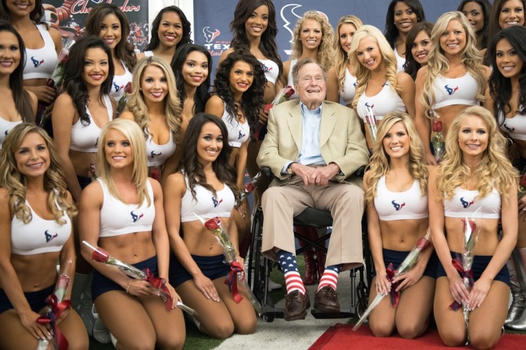 Former President George H.W. Bush poses for a group photo with the newly-announced Houston Texans cheerleaders.