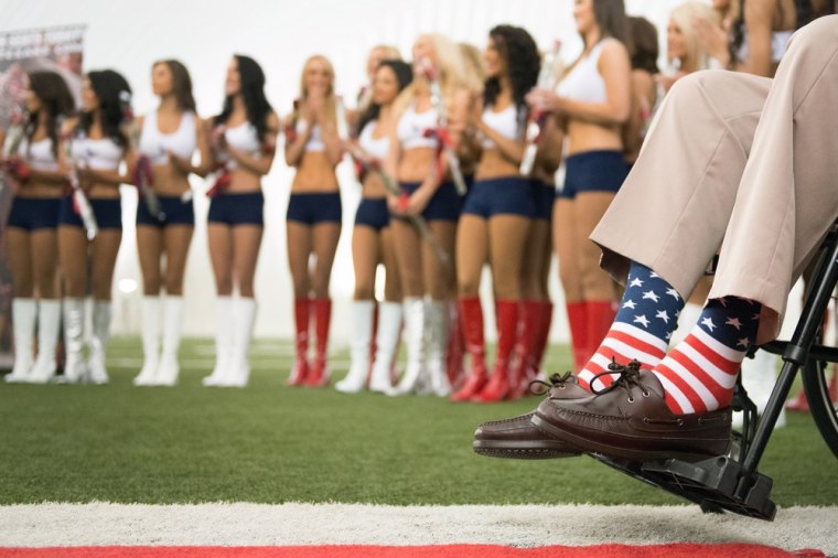 George H.W. Bush wears American flag socks at a ceremony introducing the 2013-2014 Texans cheerleaders.
