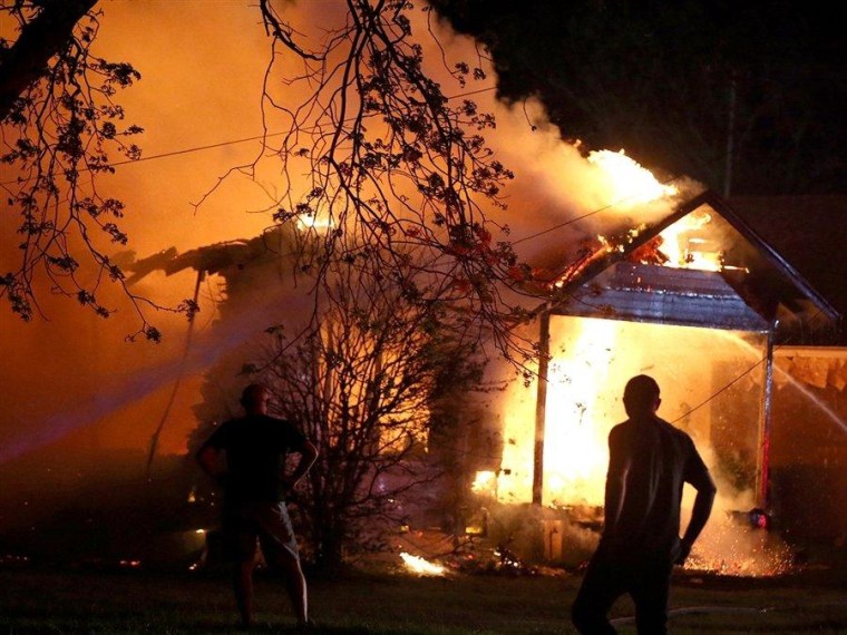 Firefighters battle a house fire after an explosion at a nearby fertilizer plant in West, Texas.