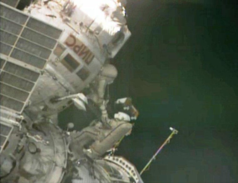 Russian cosmonauts Roman Romanenko (bottom) and Pavel Vinogradov float outside the International Space Station on Friday during a spacewalk.
