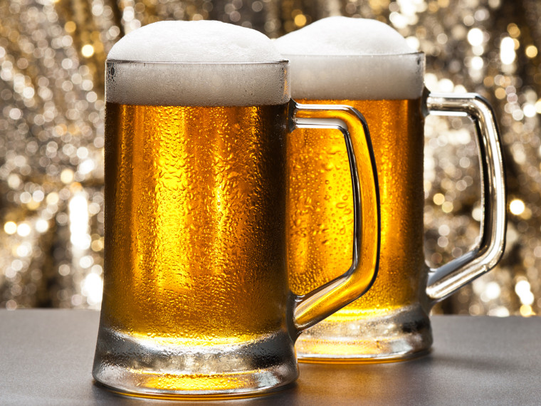 Beer mug in front of a glittering background with a cool beer