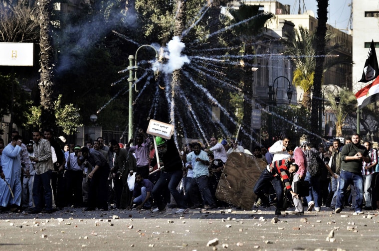 Muslim Brotherhood supporters throw stones towards opponents during clashes on April 19, in central Cairo.