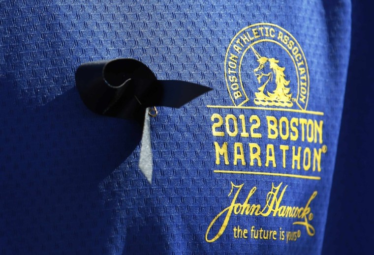 Jason Darnall of Kentucky, who ran the Boston Marathon in 2012 and chose to compete in London's marathon on Sunday, wears a black ribbon at the start of the mass race in Greenwich Park, southeast London.