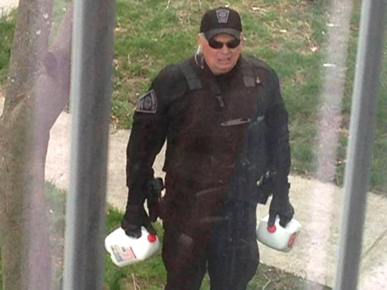 A photo has gone viral of Brookline (Mass.) police officer John Bradley delivering milk to help a couple with a 17-month-old boy while the neighborhood was on lockdown during the hunt for the alleged Boston Marathon bombing suspect. 